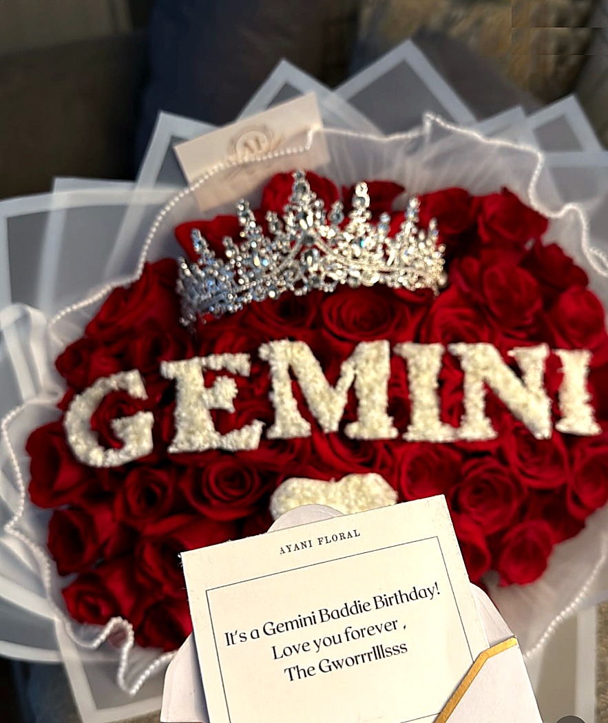 Red rose birthday arrangement with Gemini floral lettering and jeweled crowns.
