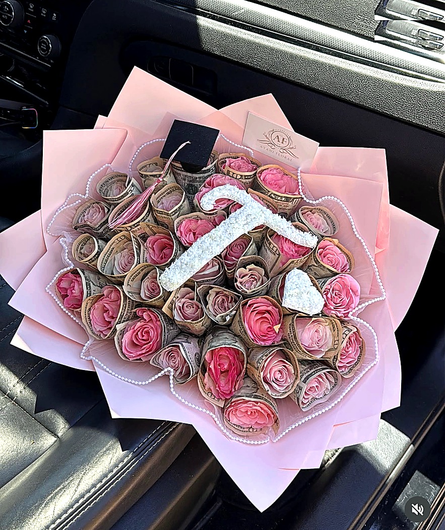 Pink luxury money bouquet made with roses and folded cash.